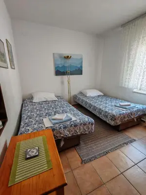 a room with two beds and a table in it at Apartman Draga Sutomore in Sutomore