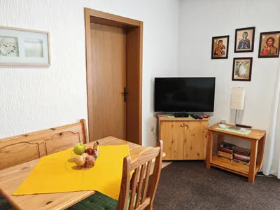 a living room with a table and a television at Apartman Draga Sutomore in Sutomore