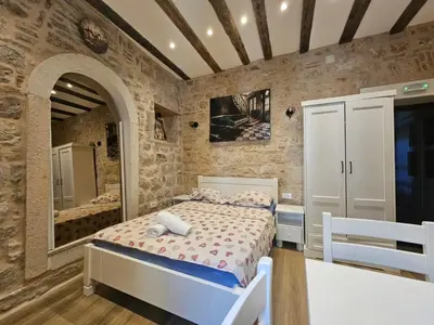 a bedroom with a bed and a mirror at patrik in Kotor