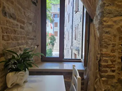 a dining room with a table and a window at patrik in Kotor