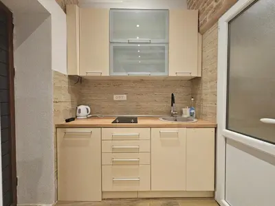 a small kitchen with a sink and a window at patrik in Kotor