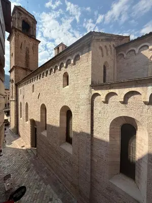 a large brick building with a clock tower in the background at Casa Campana in Kotor