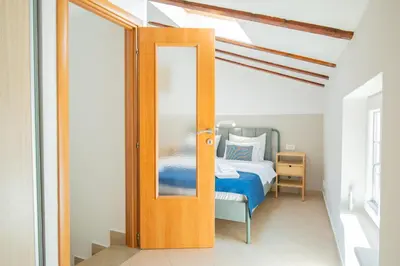 an open door to a bedroom with a bed at Casa Campana in Kotor