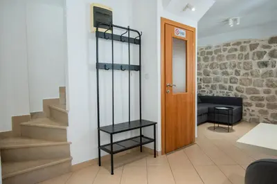 a room with stairs and a wooden door at Casa Campana in Kotor