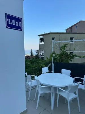 a white table and chairs sitting on a patio at DD apartment in Budva