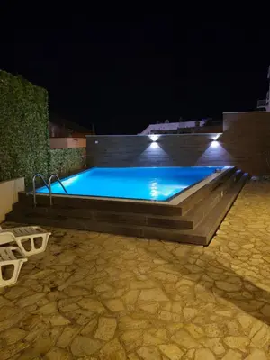 a swimming pool at night with a slide at Apartman Bucan in Ulcinj
