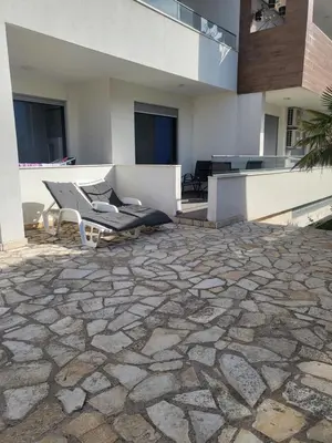 a patio with a couch and chairs on a building at Apartman Bucan in Ulcinj