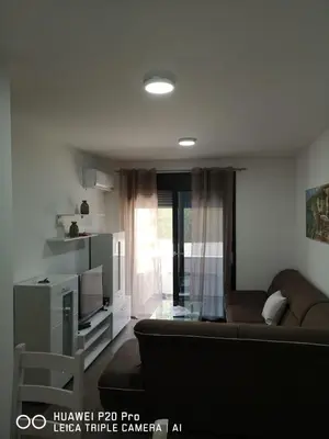 a living room with a couch and a tv at Apartman Bucan in Ulcinj
