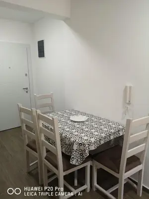 a dining room table and chairs with a black and white table cloth at Apartman Bucan in Ulcinj