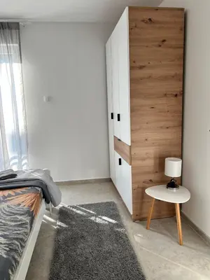 a bedroom with a bed and a table with a lamp at A&A apartments in Kravlja
