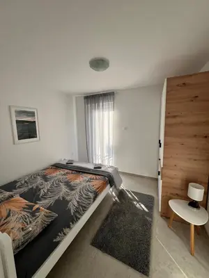 a bedroom with a large bed and a window at A&A apartments in Kravlja