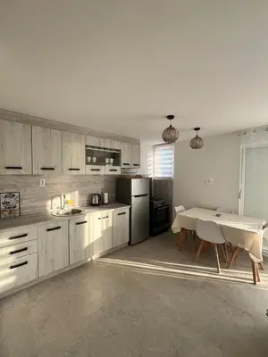 a kitchen with a table and a refrigerator and a table at A&A apartments in Kravlja