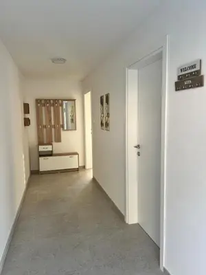 an empty room with a hallway with a door at A&A apartments in Kravlja