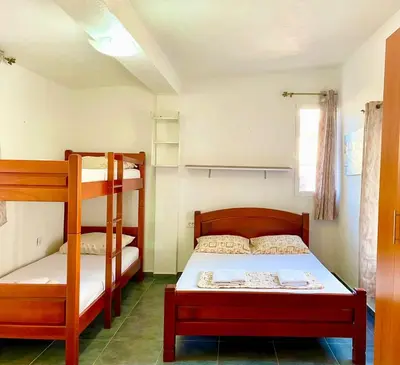a bedroom with two bunk beds and a bed at ground apartaments with balcony in Kotor