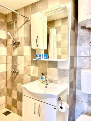 a bathroom with a sink and a shower at ground apartaments with balcony in Kotor