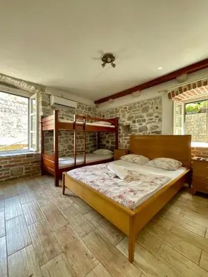 a bedroom with a bed and two bunk beds at sar 2 in Kotor