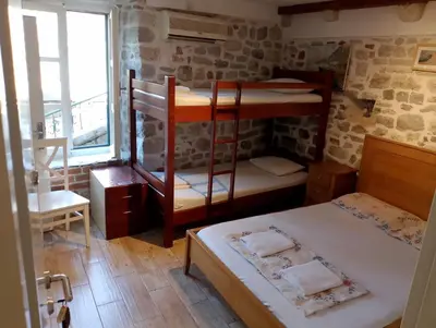 a room with two bunk beds and a window at sar 2 in Kotor