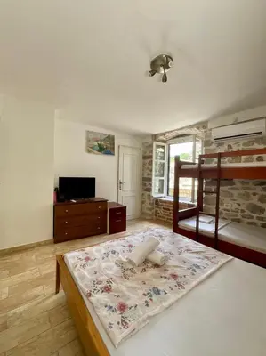 a bedroom with a bunk bed and a television at sar 2 in Kotor