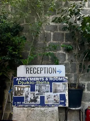 a sign in front of a brick wall with a sign at sar 3 in Kotor