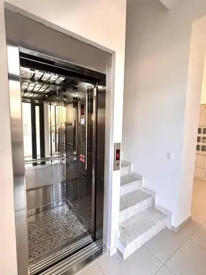 a elevator in a building with a glass door at Amd Apartmani in Dobra Voda