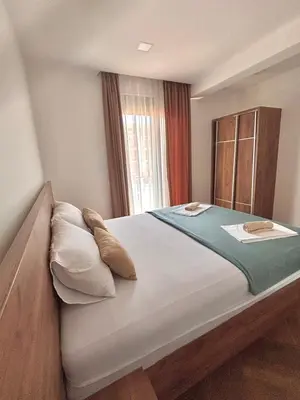 a large bed in a room with a window at Amd Apartmani in Dobra Voda