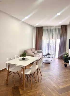 a living room with a table and chairs and a couch at Amd Apartmani in Dobra Voda