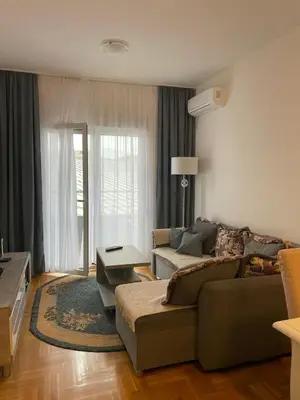 a living room with a couch and a table at Aurora 3 Apartment in Budva