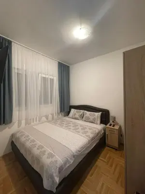 a small bedroom with a bed and a window at Aurora 3 Apartment in Budva