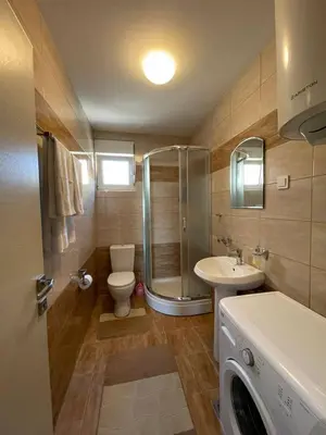 a bathroom with a shower and a toilet and a sink at Aurora 3 Apartment in Budva