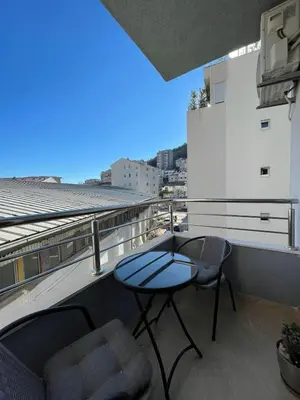 a patio with a table and chairs on a balcony at Aurora 3 Apartment in Budva