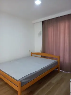 a bedroom with a bed in a room with a curtain at Markovići Studio
