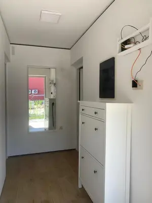 a living room with a tv and a dresser at Markovići Studio