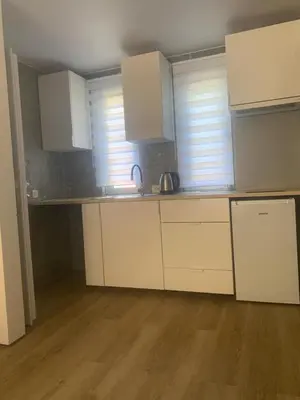 a kitchen with white cabinets and a counter top at Markovići Studio