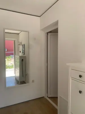 a white room with a mirror on the wall at Markovići Studio