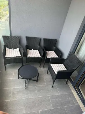a group of chairs and a table in a room at Skyline lux apartman Becici sa pogledom na more in Budva