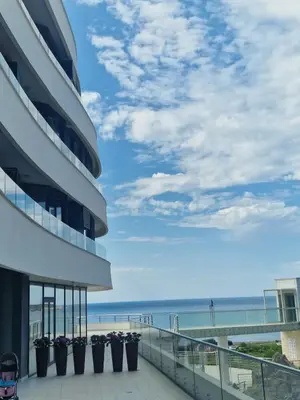 a view of the beach from the balcony of a building at Skyline lux apartman Becici sa pogledom na more in Budva
