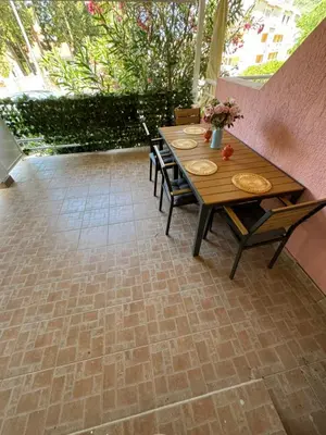 a patio with a wooden table and chairs at Apartman Luka5 in Petrovac na Moru
