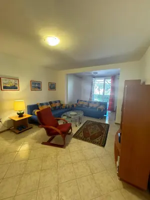 a living room with a couch and a chair at Apartman Luka5 in Petrovac na Moru