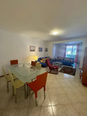 a living room with a table and chairs and a couch at Apartman Luka5 in Petrovac na Moru