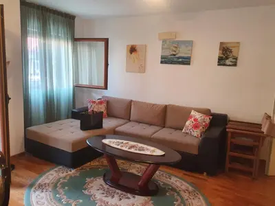 a living room with a couch and a table at Apartman Elena Budva in Budva