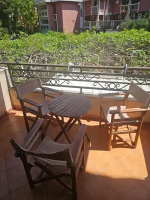 a table and chairs on top of a balcony at Apartman Elena Budva in Budva