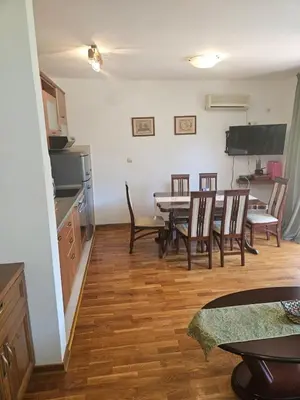 a kitchen and dining room with a table and chairs at Apartman Elena Budva in Budva