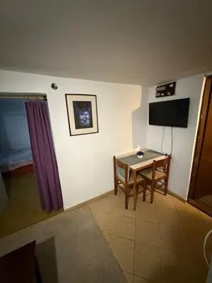 a living room with a table and a television at Apartman centar in Podgorica