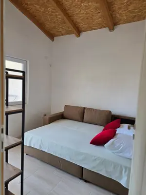 a bedroom with a bed with red pillows on it at Apartment on Long Beach Velika plaza near Ada Bojana in Ulcinj