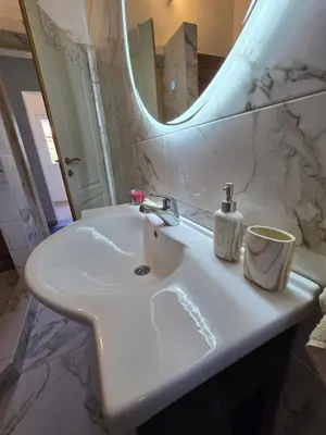 a white sink in a bathroom with a mirror at Apartment on Long Beach Velika plaza near Ada Bojana in Ulcinj