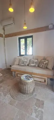 a living room with a couch and a coffee table at Sunrise Nest - Tinyhouse in Bar