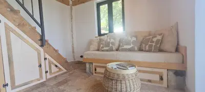 a small room with a bench and a window at Sunrise Nest - Tinyhouse in Bar