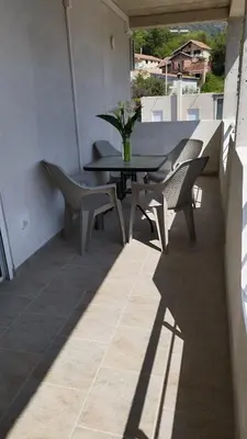 a patio with a table and chairs on a balcony at Apartman Živaljević 1 Tivat in Tivat
