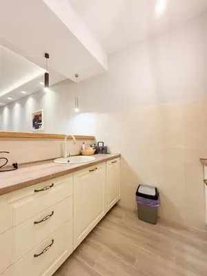 a kitchen with white cabinets and a sink at Modern 1-bedroom apartment M25 in Podgorica