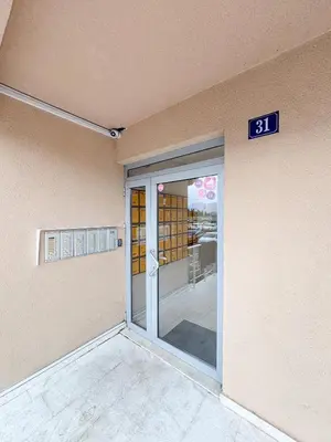 a door to a building with a sign on it at Modern 1-bedroom apartment M25 in Podgorica